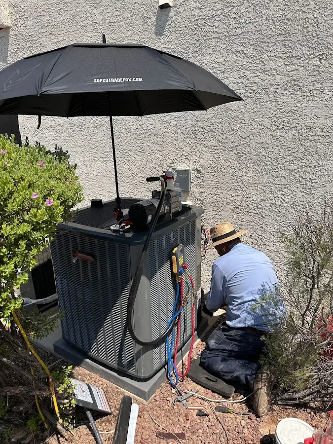 HVAC technician performing outdoor AC maintenance in Hoffman Estates